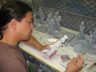 Fon is painting an Usagi Yojimbo statue prototype. The statues were each molded, cast, and created as gray assembled versions. They were then disassembled, painted and reassmbled as painted versions.  https://youtu.be/fxnmeHHEGeQ	