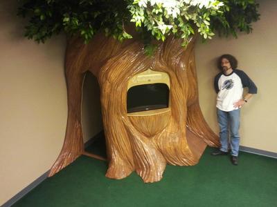 This a preschool space we created featuring a tree playhouse with an interchangeable TV and puppet theater.	