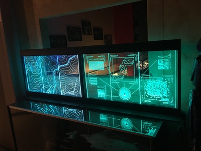 These are laser etched, RGB LED illuminated displays. We created and installed several at the Scum and Villainy bar. Others were created for a sci-fi laboratory set dressing and are available for rent.	