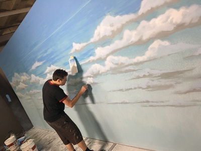 This is one of our many painted sky backdrops avail be for rent in the process of being painted by one of our talented artists.	